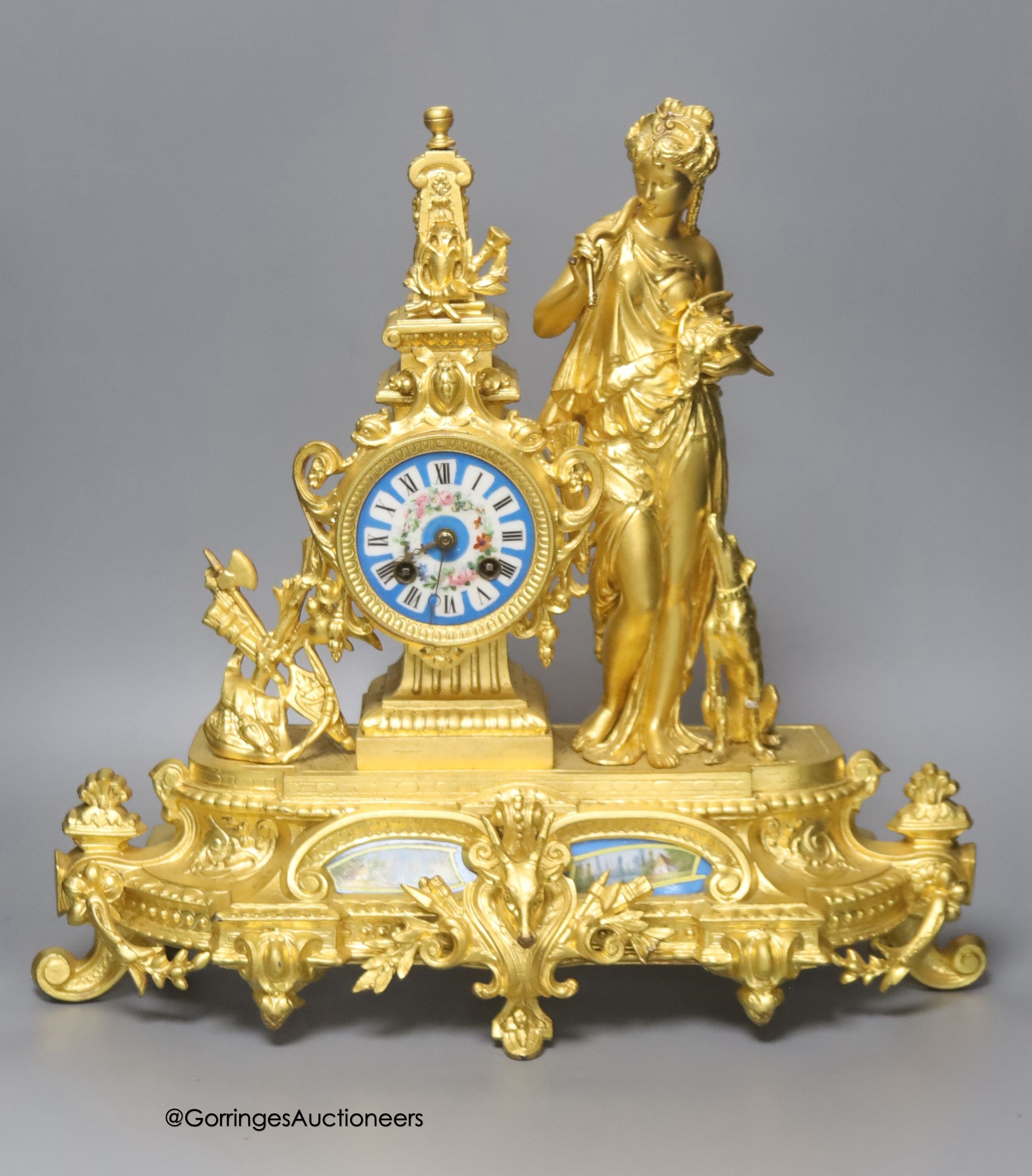 A late 19th century French gilt metal figural mantel clock, with Sevres style inserts, with key and pendulum, height 42cm